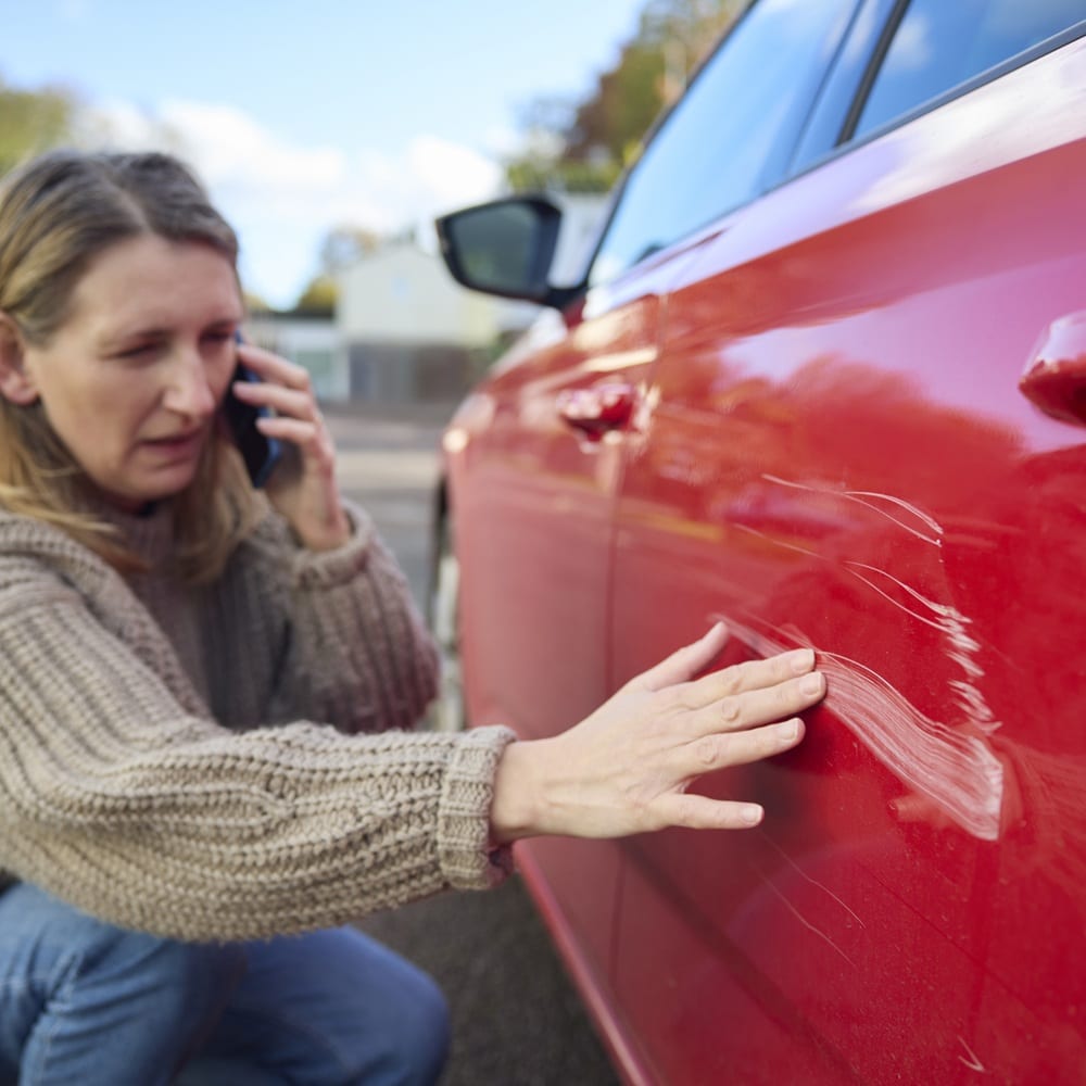 Unhappy Mature Female Driver With Damaged Car After Accident Calling Insurance Company On Mobile Phone